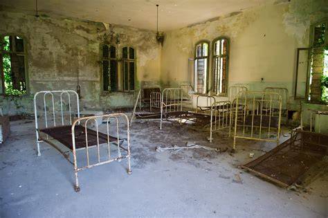 Interiér bývalej psychiatrickej nemocnice v Bytčici s grafitmi a rozbitými oknami